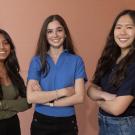 All three Goldwater Scholars posing for a picture in front of a plain salmon colored wall.
